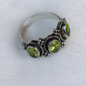 Sterling silver ring with three peridot stones. Total weight is 5.85 grams
